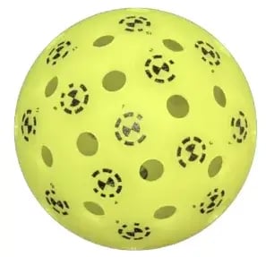 Yellow pickleball printed with circular coded tracking markers, used in the PaddleVision spin rate test